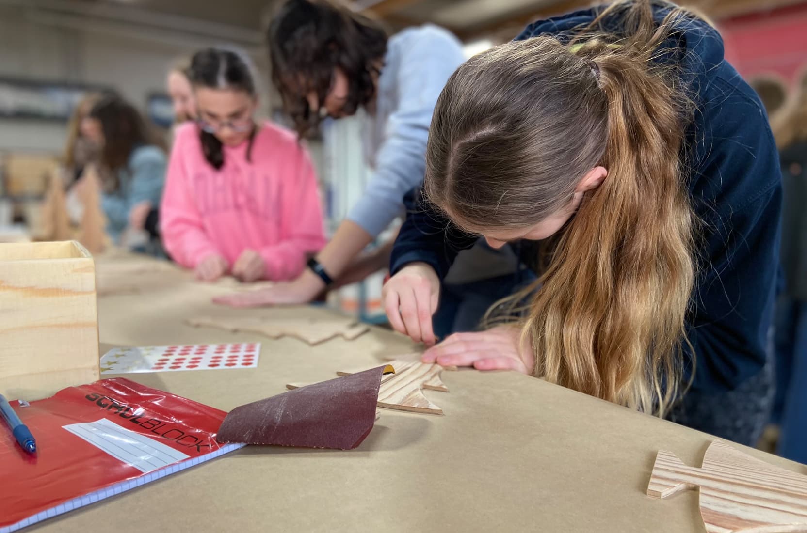 Schüler an der Werkbank in der Schreinerei bei deka Messebau