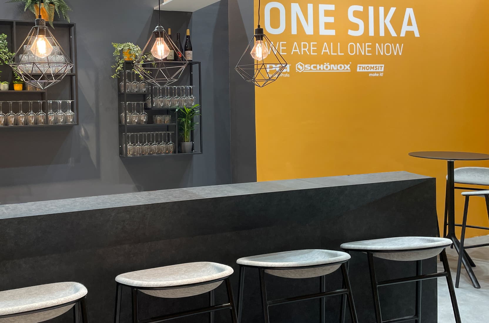 Bartheke mit Hängeleuchten auf dem Messestand von Sika auf der Messe Bau 2025 in München